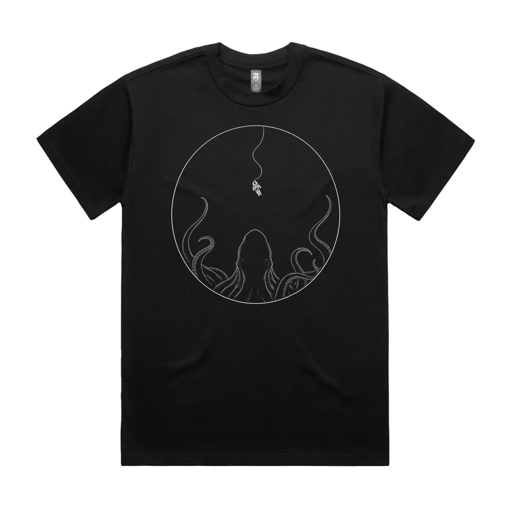 Front mockup of Vestigium XIII luxury 280 GSM heavyweight black t-shirt featuring a striking cosmic-dread illustration of a lone astronaut tethered in deep space, suspended directly above the massive silhouette of a colossal cephalopod rising from the darkness printed in monochrome ink.